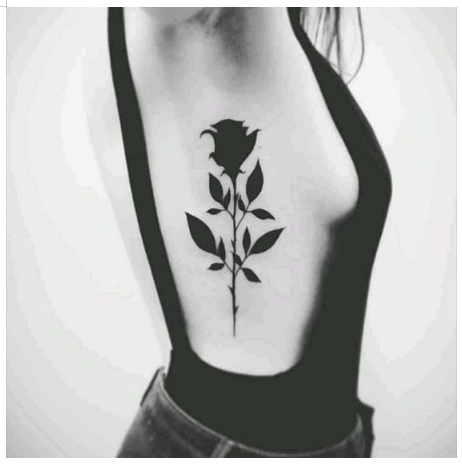 Microrealistic rose tattoo on the rib
